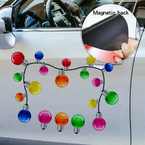 Detail of Christmas magnetic bulb stickers showing the black magnetic back on a white car