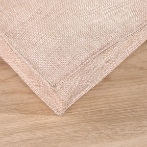 Detail of light brown fabric seat cushion with durable woven texture and reinforced stitching