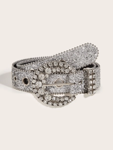 Detail of silver rhinestone belt with sparkling round buckle and metallic eyelets decor