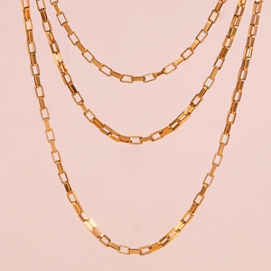Detail of 18K gold-plated stainless steel rectangular box chain with polished finish