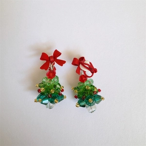 Detailed top view of handmade beaded crystal Christmas tree earrings with red ribbon bows