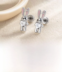 Macro detail of cute rabbit stud earring with pink enamel and heart-shaped zircon