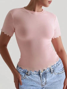 Slim fit pink short sleeve yoga top with wavy hem detailing and soft knit texture