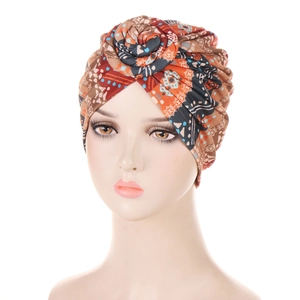 Detail of bohemian snail-style turban with ethnic orange and brown geometric print