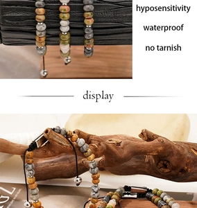 Detail of natural green map stone beaded bracelet with adjustable black braided cord