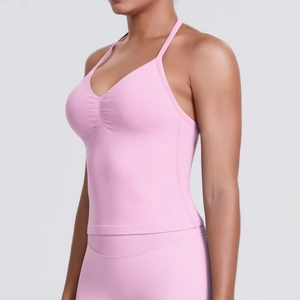 Side view detail of seamless pink yoga tank top with thin straps and ruched chest design