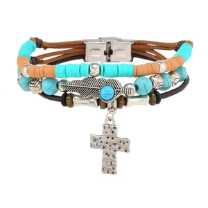 Detail of multi-layer leather bracelet with turquoise beads, feather and cross pendants