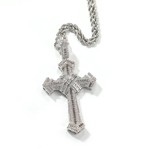 Macro shot of silver cross pendant with shimmering cubic zirconia and rope chain detail