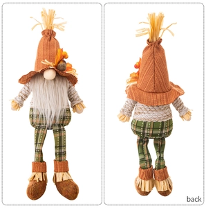 Front and back views of an autumn gnome doll with an orange hat and straw boots
