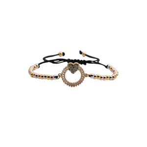 Adjustable woven bracelet with gold-plated beads and a colorful zircon heart charm