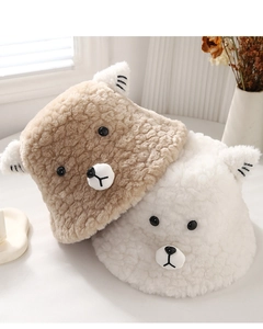 Detail view of plush teddy fleece bucket hats with cute bear ears in brown and white