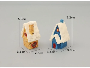 Detailed view of miniature snow-covered resin houses for Christmas desktop decoration