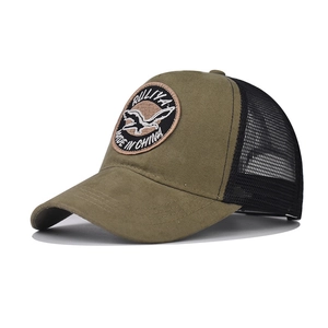 Detail of army green trucker hat with flying bird embroidery and black mesh back