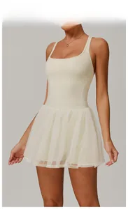Close-up of the square neck bodice and layered mesh skirt in creamy apricot color