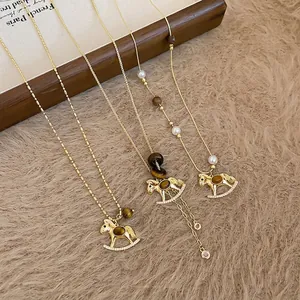 Golden pony necklace with tiger eye stone and zircon, styled with pearls and wooden beads