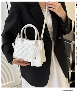 White quilted PU leather handbag with matching coin purse shown on a fashion model