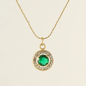 Detailed view of an 18K gold-plated necklace with a round green zircon stone and crystals