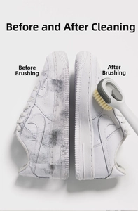 Detail of shoe brush cleaning white leather sneakers showing effective stain removal result