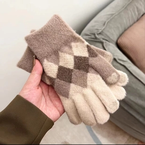 Close-up of argyle knit pattern on winter touchscreen gloves with wool-like texture