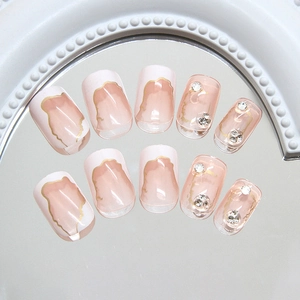 French style press-on nails with gold edges and rhinestones on a mirror base