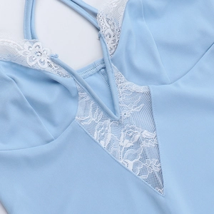 Detail of light blue mini dress featuring fine white floral lace and thin cross straps