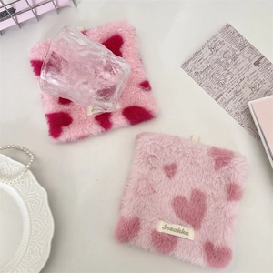 Pink plush square coasters with heart pattern for home decor and desktop photography