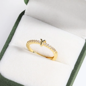 Close-up of gold 18k plated adjustable ring with letter Y and diamonds in a green box
