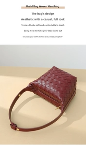 Close-up of burgundy woven leather texture and elegant gold metallic zipper hardware