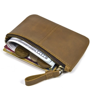 Detail view of brown genuine leather coin purse showing interior card and cash capacity