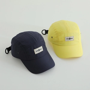 Detail of quick-dry camper hats with adjustable buckle and bear logo embroidered patch