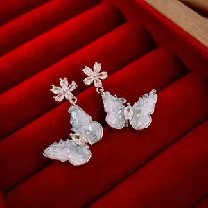 Elegant butterfly and flower crystal earrings in silver with blue zircon butterfly wing detail