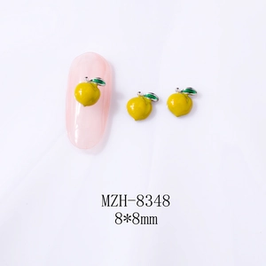 Detail of yellow peach alloy nail charm 8x8mm with green leaf on translucent pink nail