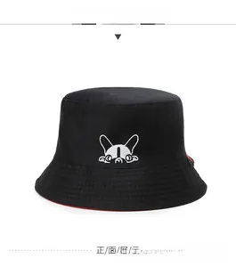 Detail of cartoon dog embroidery on a black canvas bucket hat with red lining accent