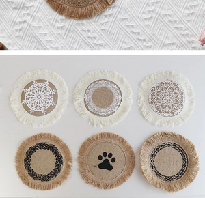 Close-up of handmade jute placemats with fringe tassels and mandala lace patterns