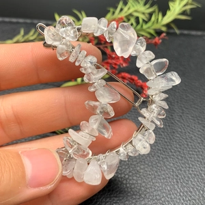 Detail view of crescent hair clip featuring clear natural crystal stones on silver base