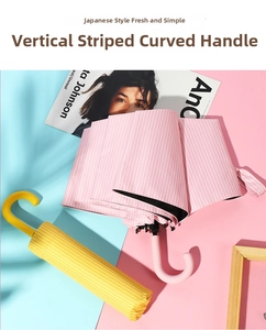Detail of pink striped parasol with curved handle and matching yellow striped protective sleeve