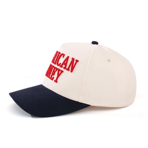 Detail of navy blue brim and cream crown baseball cap with red 3D letter embroidery