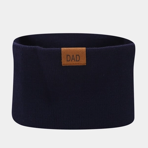 Close-up of navy knit neck warmer with a brown leather patch featuring DAD lettering