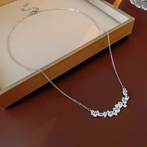 Macro detail of wheat-ear zircon necklace pendant on an open jewelry box