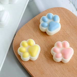 Detailed macro view of cute cat paw silicone molds in macaron blue, yellow and pink shades