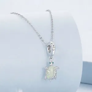 Luminous turtle pendant in 925 sterling silver with green stone and heart detail