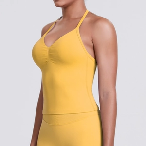 Detail of yellow seamless sports tank top featuring slim straps and a pleated V-neckline