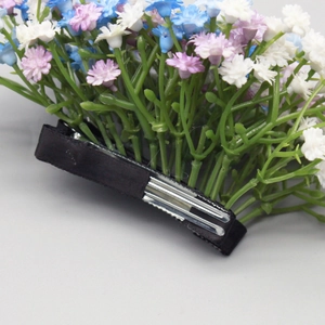Close-up of elegant floral duckbill hair clip with blue and purple gypsophila flowers