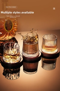 Detail view of rotating whiskey glasses with three textures and wooden coasters