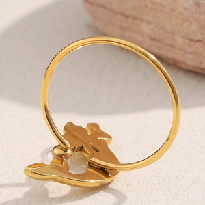 Detailed macro view of 18K gold mermaid charm with pearl on large hoop earring