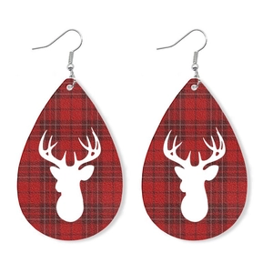Detail of teardrop leather earrings featuring red plaid pattern and white reindeer silhouette