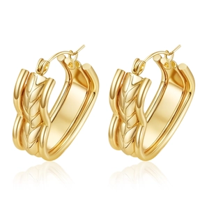 Fashionable gold wide hoop earrings with textured woven pattern on white background