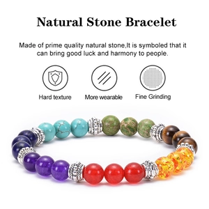 Macro detail of natural stone beads showing polished texture and lucky charm symbols