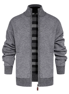Detailed knit texture of a men's grey zip-up cardigan with dark plaid inner lining