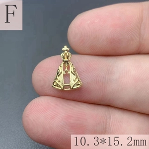 Macro shot of 18k gold plated Virgin Mary pendant with crown detail measuring 10.3x15.2mm